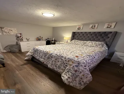 a bed sitting in a bedroom next to a lamp