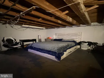 a bed sitting in a room next to a blue wall