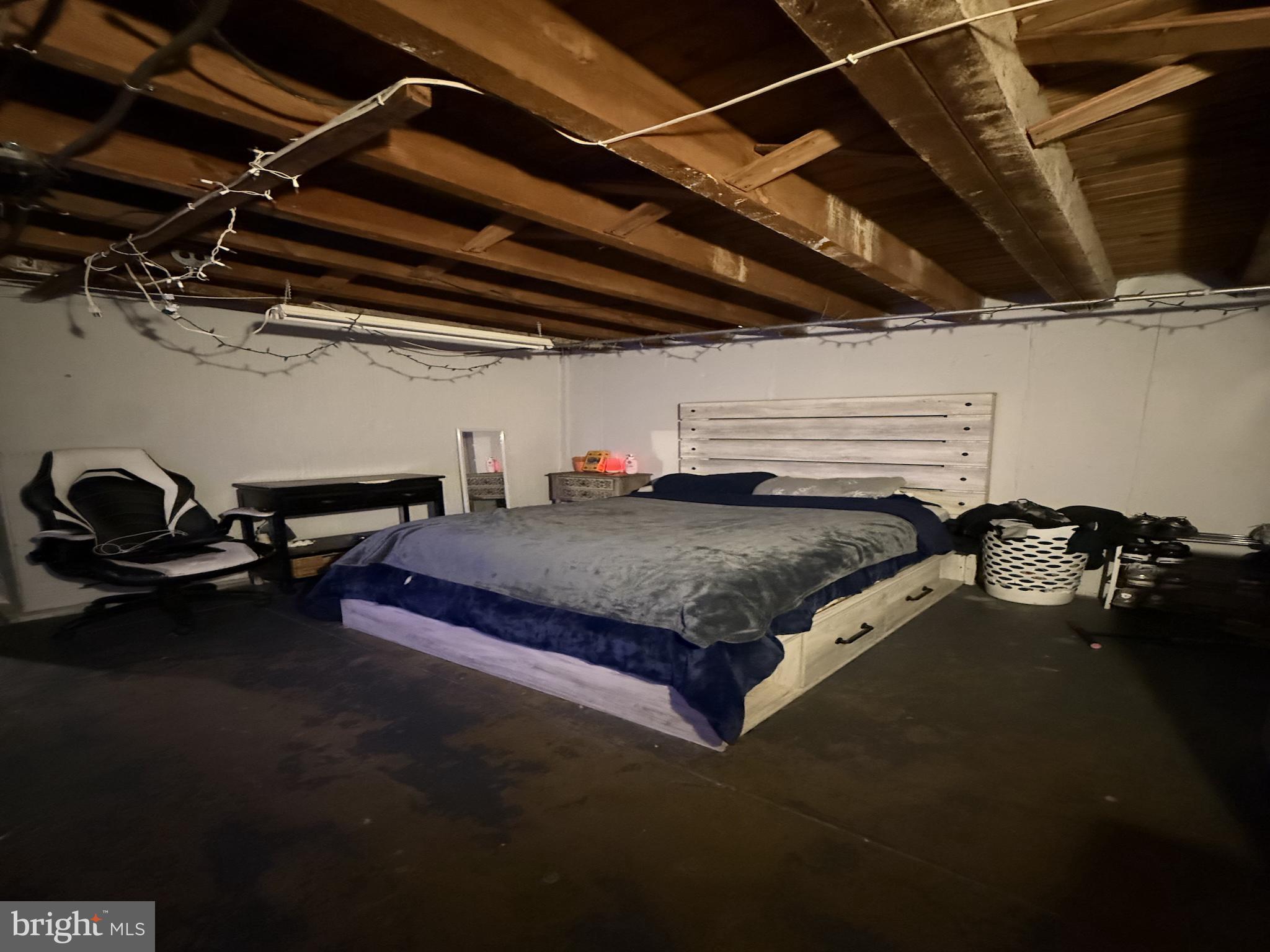229 West 22nd Street Chester, PA 19013 - Photo 15 of 18 a bed sitting in a room next to a blue wall
