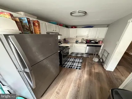 a kitchen with refrigerator and window