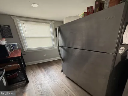 a view of a hardwood floor and a window in an empty room