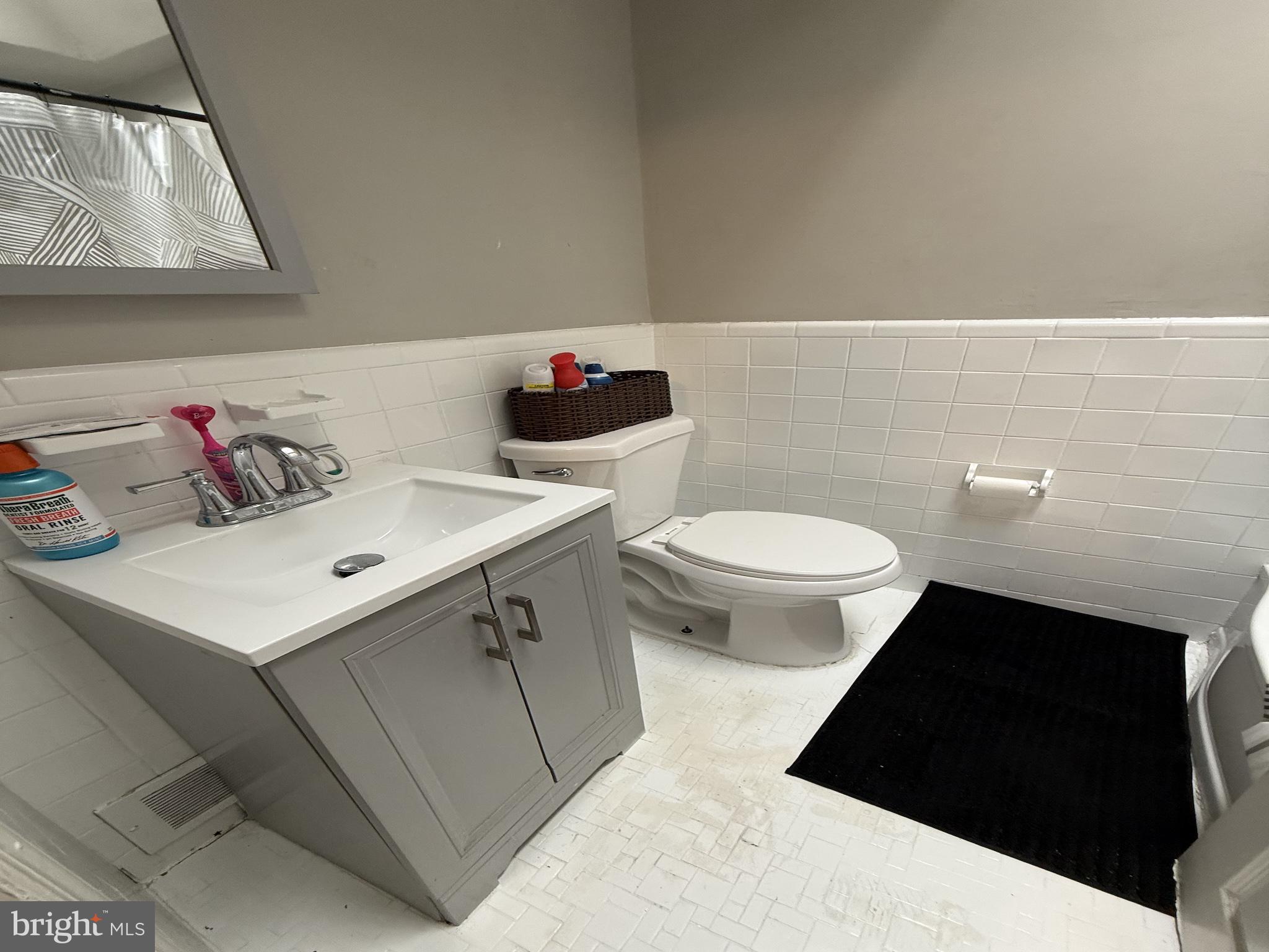 229 West 22nd Street Chester, PA 19013 - Photo 10 of 18 a bathroom with a sink and a toilet