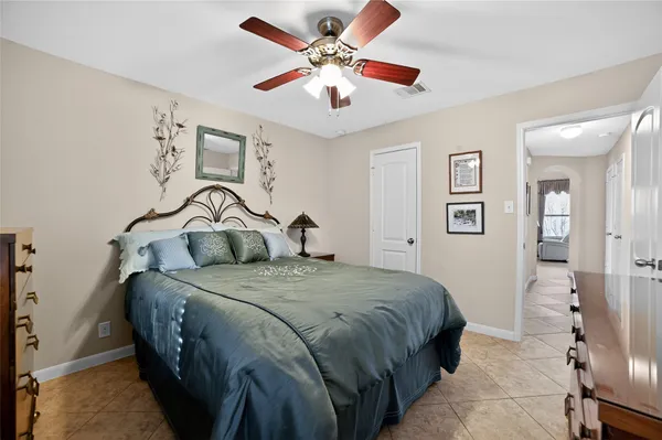 a spacious bathroom with a granite countertop tub a double vanity sink a window and a mirror