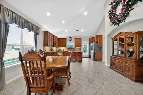 a kitchen with stainless steel appliances granite countertop a refrigerator and a sink