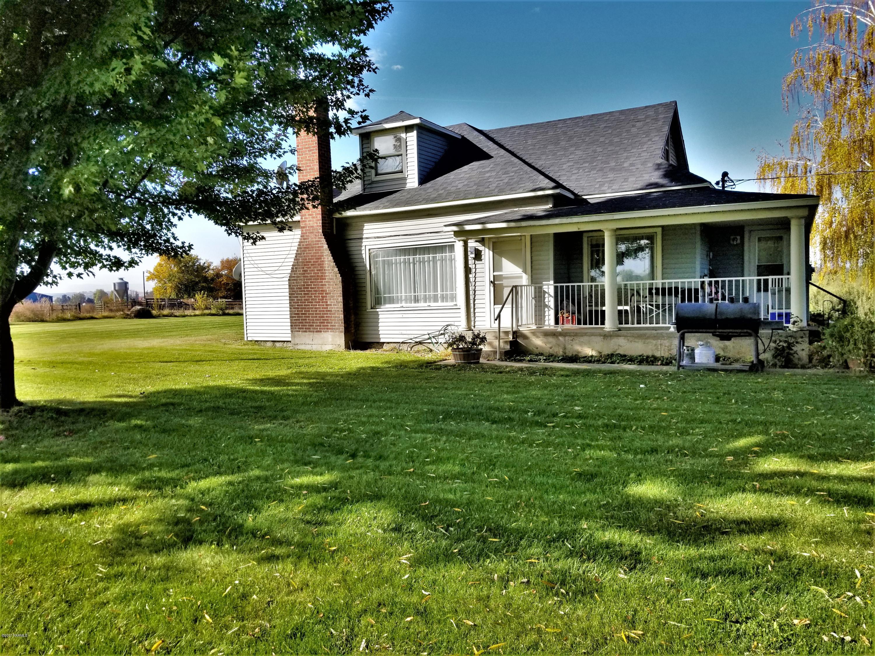 1900 Liberty Road Granger, WA 98932 - Photo 10 of 12 a front view of a house with a yard table and chairs