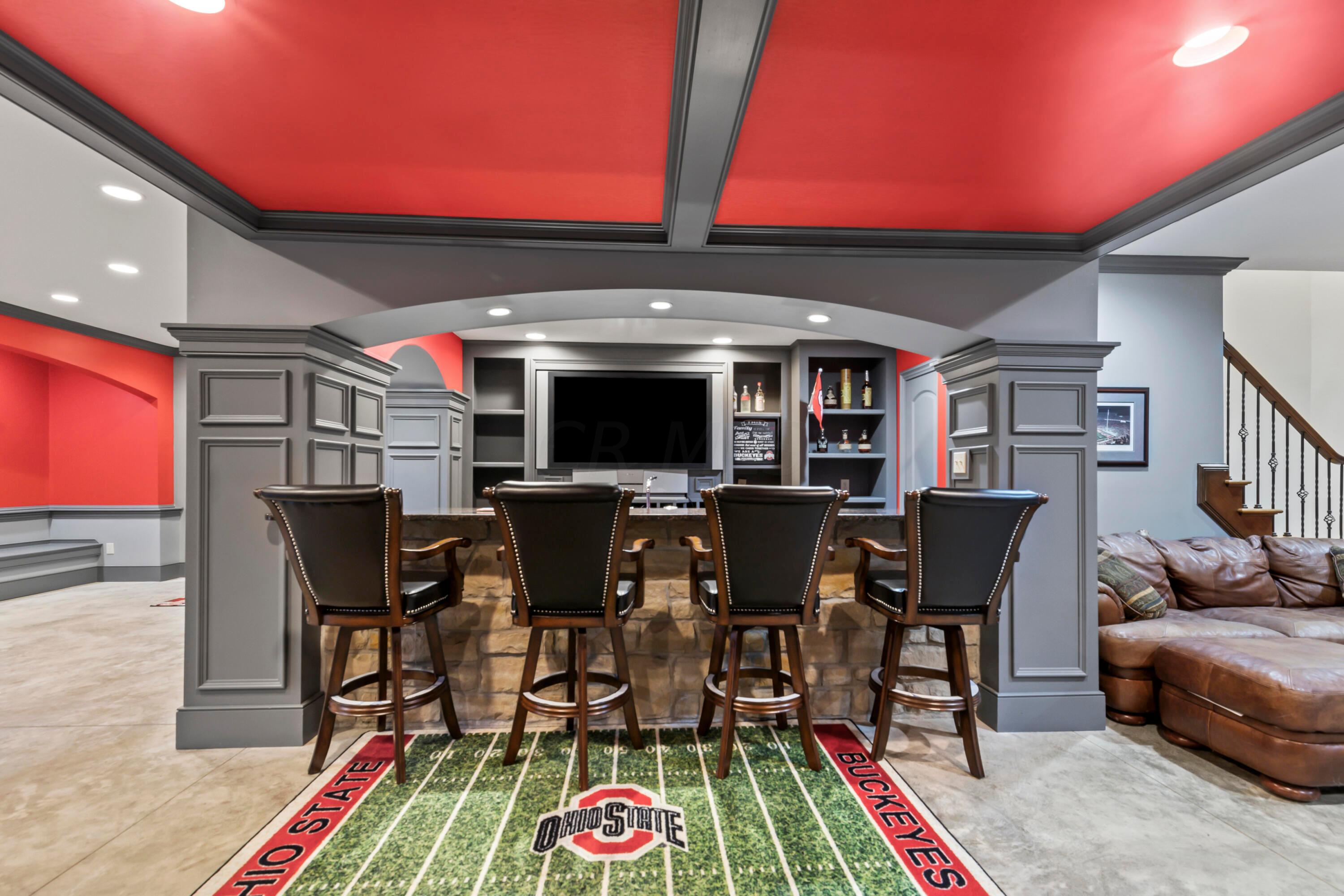 6043 Dublin Road Delaware, OH 43015 - Photo 52 of 98 • Concrete flooring
• Scarlet & grey painted walls
• Can lighting
• Beverage center remains
• Built-in entertainment
center
• Built-in shelves
• Closet under stairs
• Laminate countertop
• Granite bar ledge
• Single bowl sink