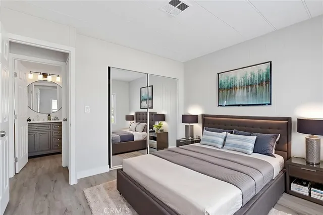 a bedroom with a balcony a bed and wooden floor