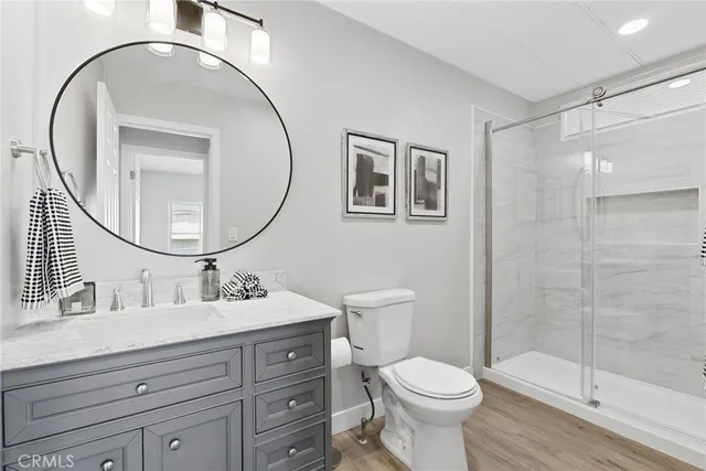 a bathroom with a toilet a sink and a mirror