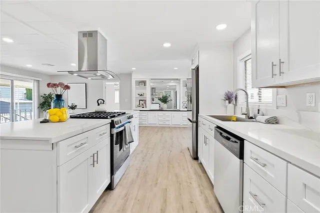 a kitchen with stainless steel appliances a sink stove and cabinets