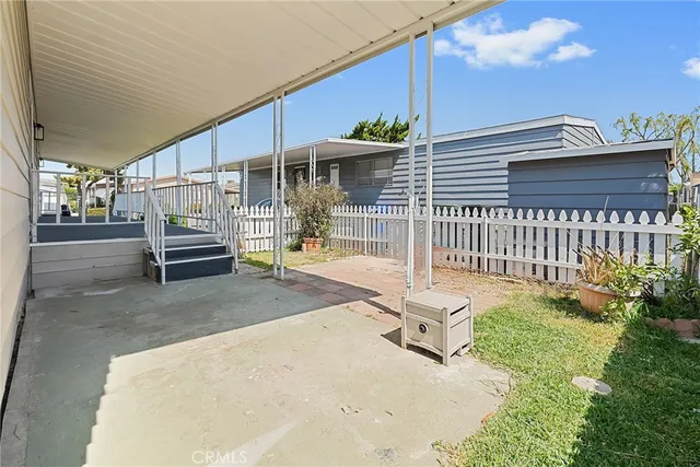 a view of a house with a porch and furniture