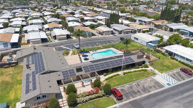 an aerial view of a house with a swimming pool outdoor seating
