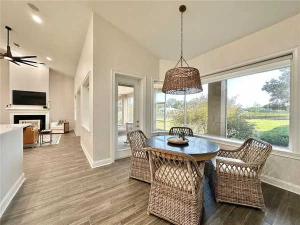 a view of a hallway with wooden floor and furniture