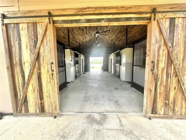a view of a hallway with wooden shelves