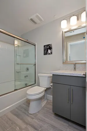 a bathroom with a sink toilet and shower