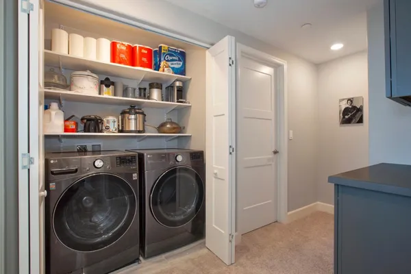 a view of a hallway with washer and dryer