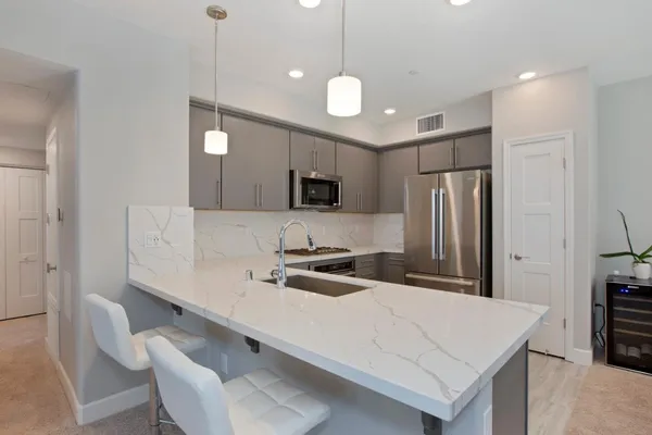 a kitchen with cabinets and stainless steel appliances