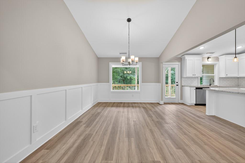 328 Advent Drive Winder, GA 30680 - Photo 14 of 45 a view of a kitchen with wooden floor and windows