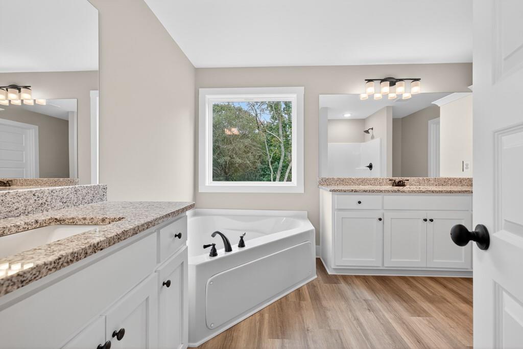 328 Advent Drive Winder, GA 30680 - Photo 19 of 45 a bathroom with a tub sink and mirror