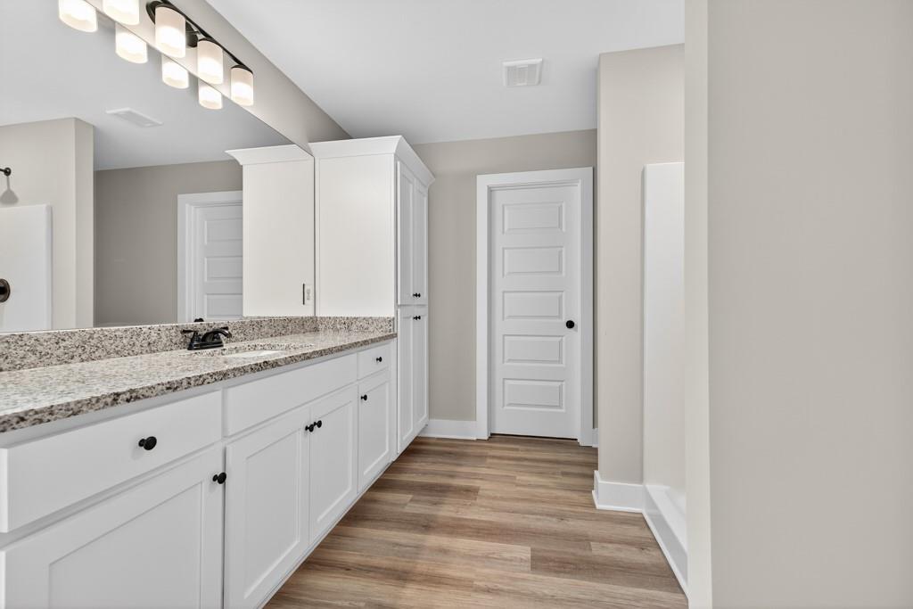 328 Advent Drive Winder, GA 30680 - Photo 20 of 45 a bathroom with a granite countertop sink and a mirror