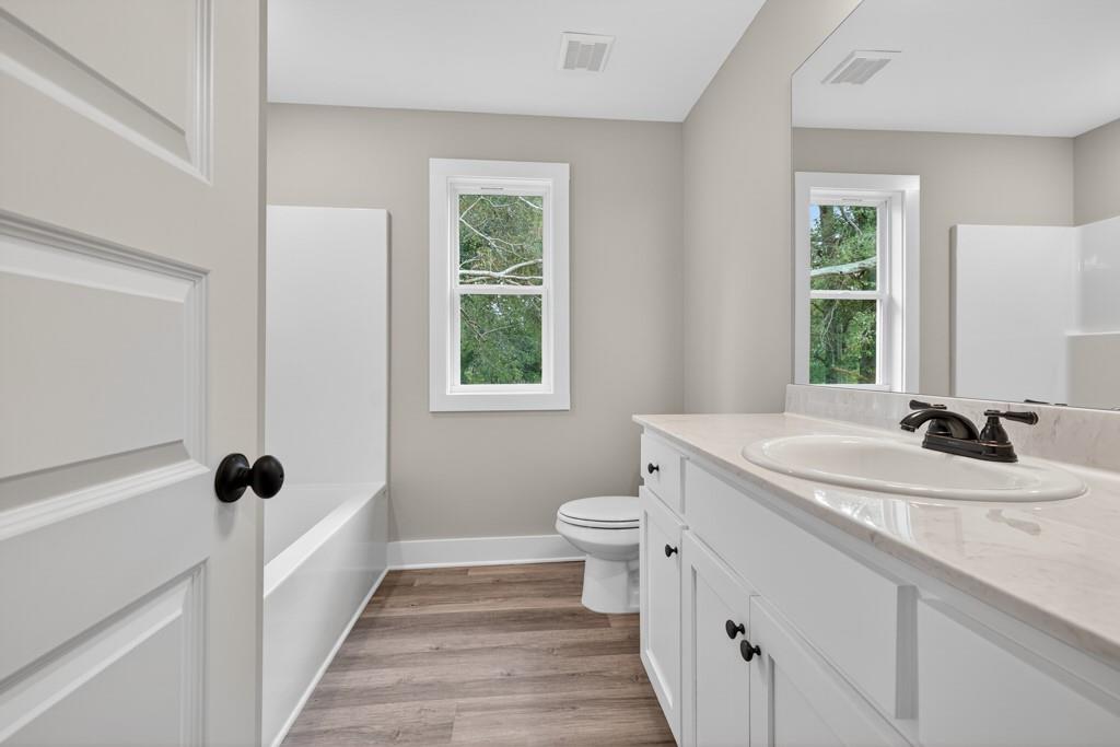 328 Advent Drive Winder, GA 30680 - Photo 28 of 45 a bathroom with a sink a toilet and a window