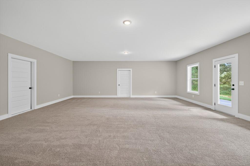328 Advent Drive Winder, GA 30680 - Photo 36 of 45 a view of a big room with windows and chandelier fan