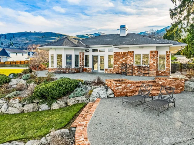 a view of a house with yard and lake view