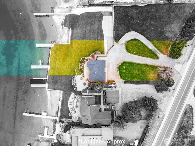 an aerial view of a house with swimming pool and outdoor seating