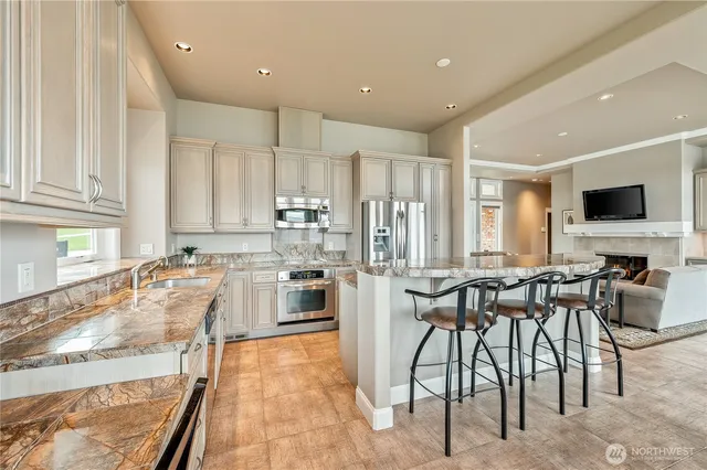 a view of a dining room with furniture large windows and wooden floor