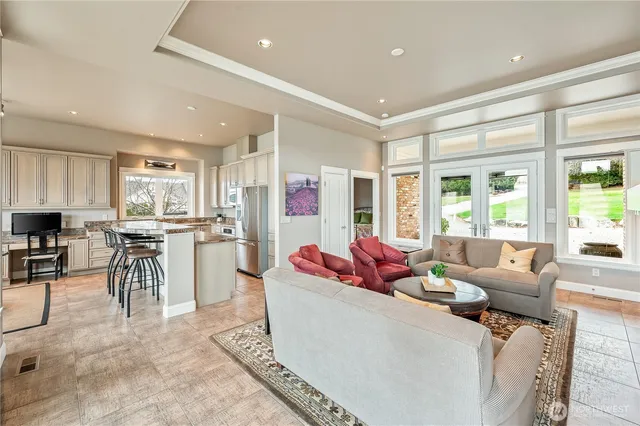 a kitchen with granite countertop white cabinets and stainless steel appliances