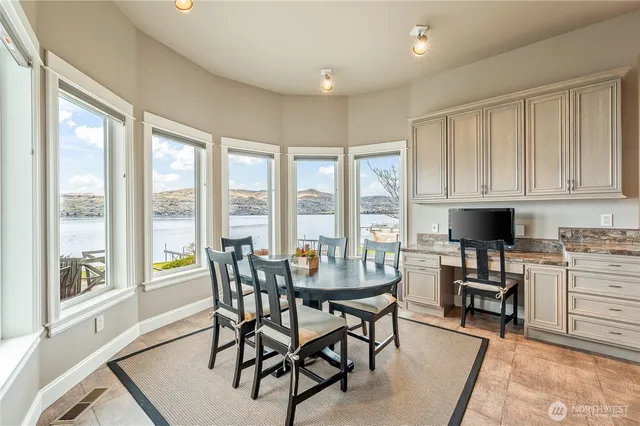 a bathroom with a granite countertop toilet sink and mirror