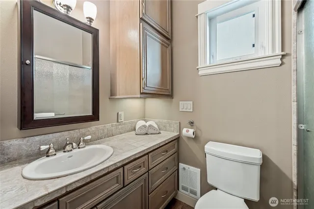 a en suite bathroom with a double vanity sink a mirror and a shower