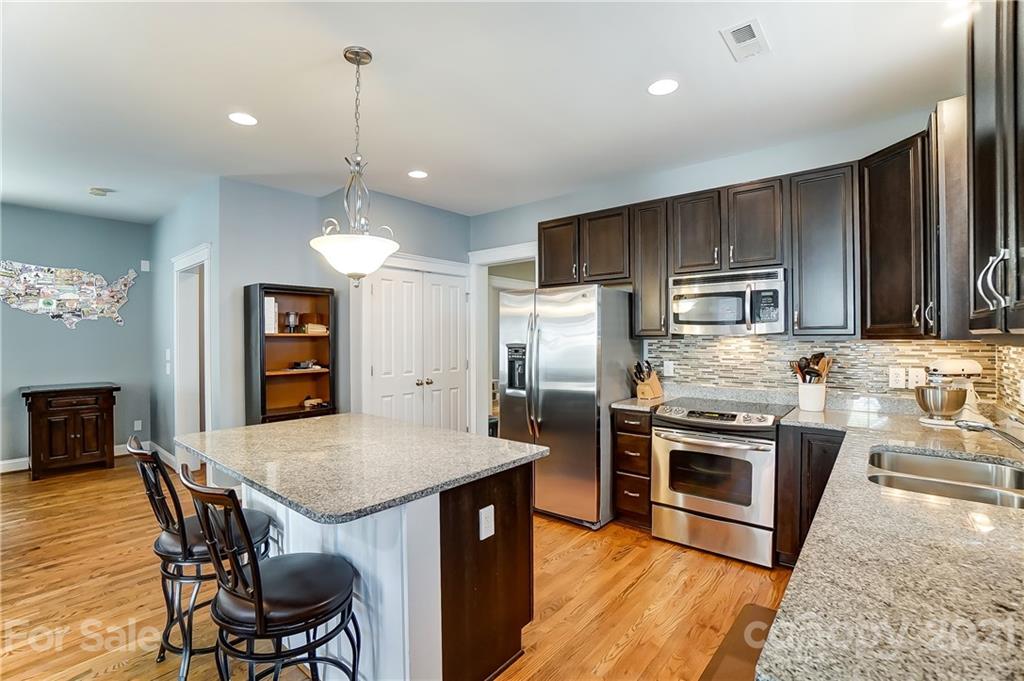 3555 Richard's Crossing Fort Mill, SC 29708 - Photo 12 of 37 a kitchen with refrigerator a stove a sink a dining table and chairs
