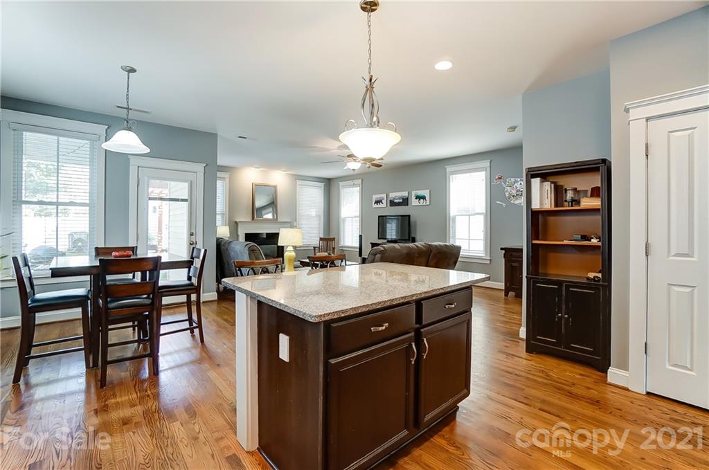 3555 Richard's Crossing Fort Mill, SC 29708 - Photo 13 of 37 a kitchen with kitchen island granite countertop a stove and a wooden floors