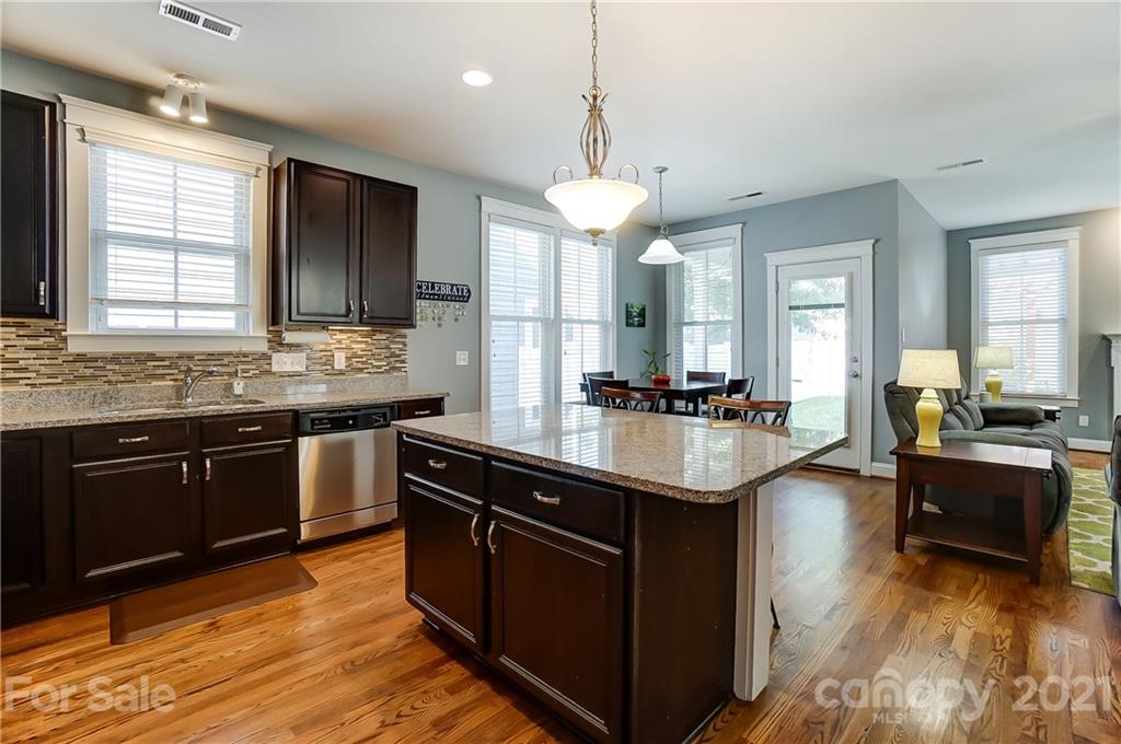 3555 Richard's Crossing Fort Mill, SC 29708 - Photo 14 of 37 a kitchen with stainless steel appliances granite countertop wooden cabinets a sink dishwasher a stove and a refrigerator with wooden floor