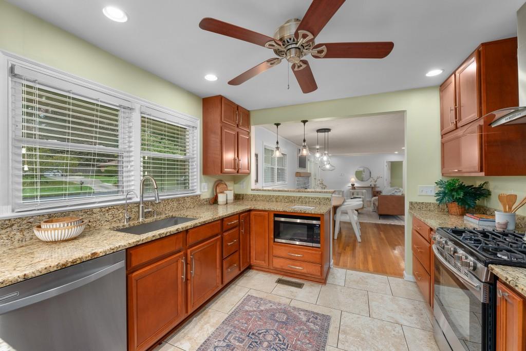 1865 Briarlake Circle Decatur, GA 30033 - Photo 14 of 32 a large kitchen with granite countertop a stove a sink a dining table and chairs