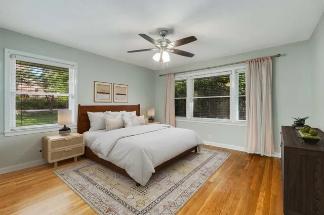 a spacious bedroom with a bed and a window