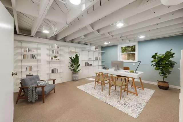 a living room with furniture a potted plant and a table