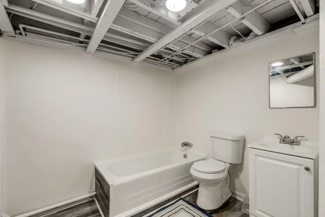 a bathroom with a toilet a sink and bathtub