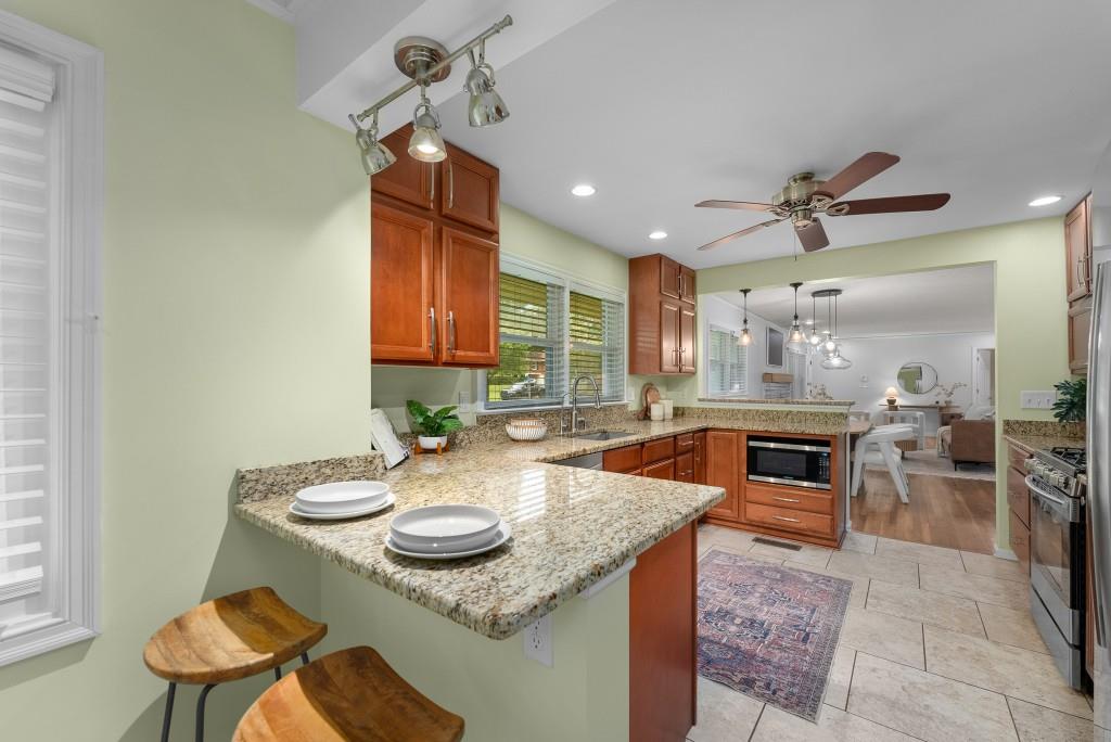 1865 Briarlake Circle Decatur, GA 30033 - Photo 4 of 32 a kitchen with stainless steel appliances granite countertop a sink a stove a dining table and chairs