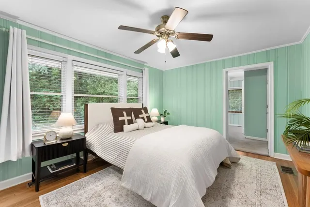 a bedroom with a large bed and a window