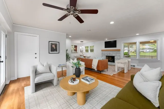 a living room with furniture a fireplace and a flat screen tv