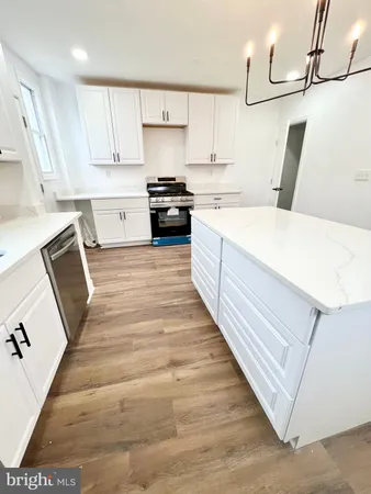 a view of a kitchen with a sink and a refrigerator