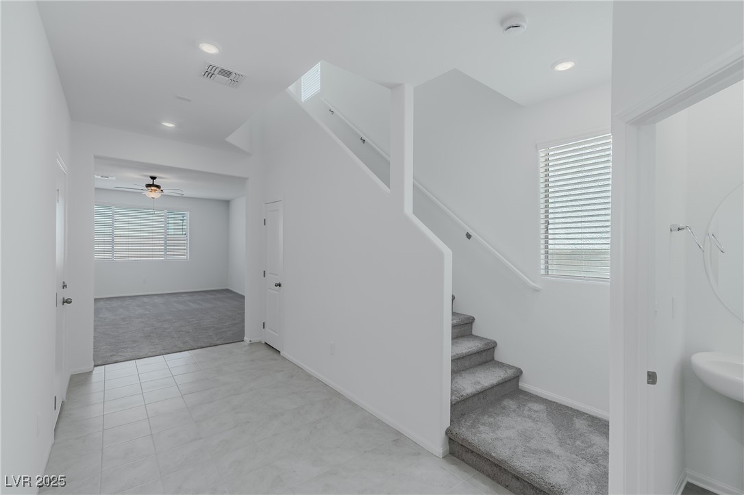 7859 Lacemaker Court Las Vegas, NV 89113 - Photo 2 of 24 Staircase featuring carpet, a ceiling fan, tile patterned floors, and recessed lighting
