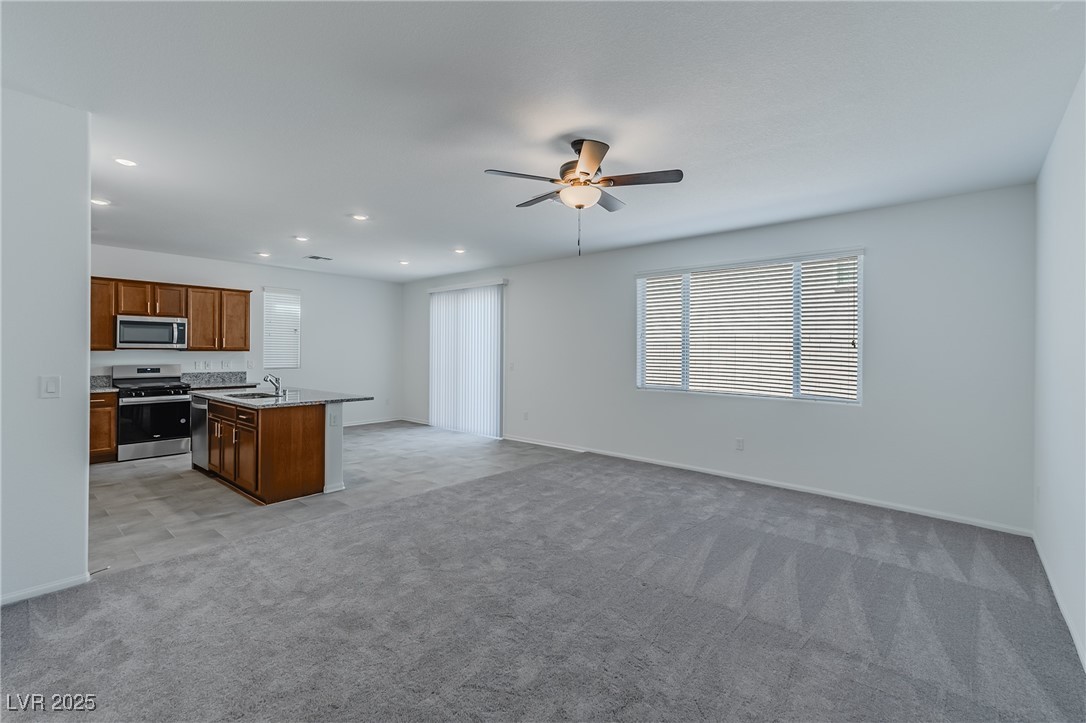 7859 Lacemaker Court Las Vegas, NV 89113 - Photo 23 of 24 Kitchen featuring open floor plan, appliances with stainless steel finishes, plenty of natural light, light carpet, and recessed lighting