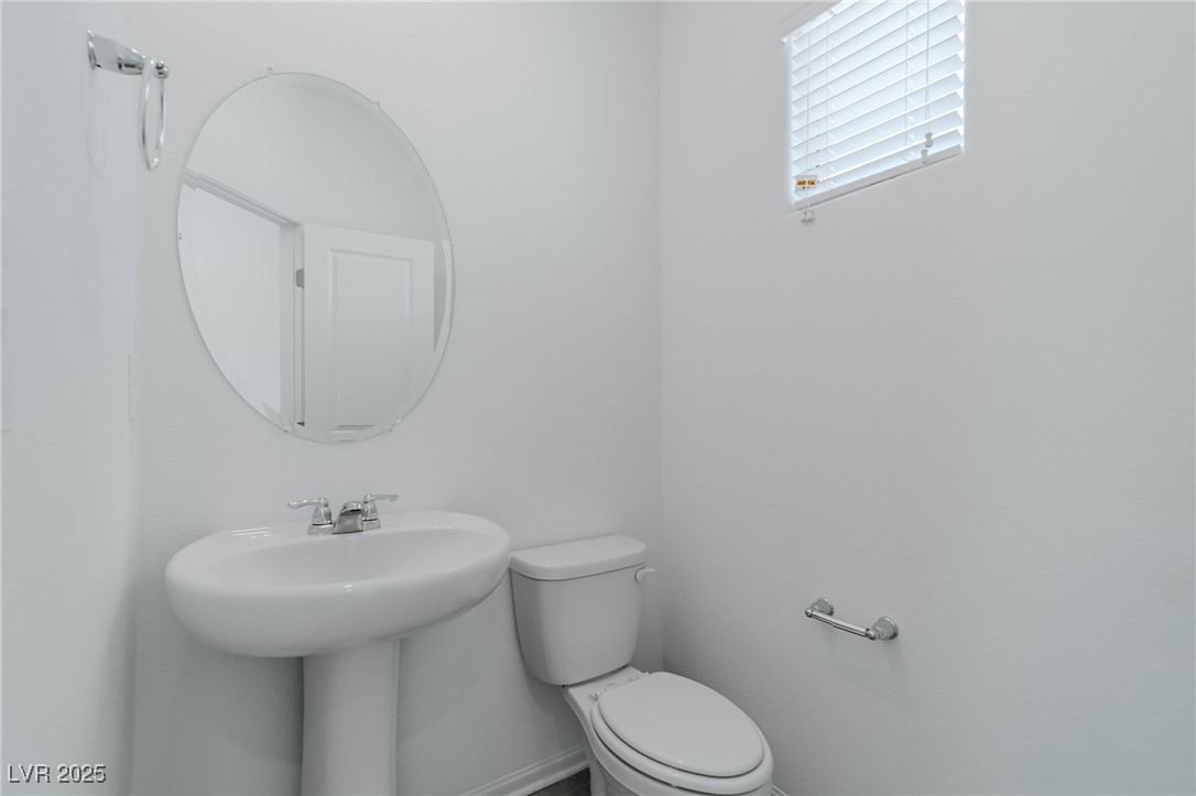 7859 Lacemaker Court Las Vegas, NV 89113 - Photo 7 of 24 Bathroom with toilet and baseboards