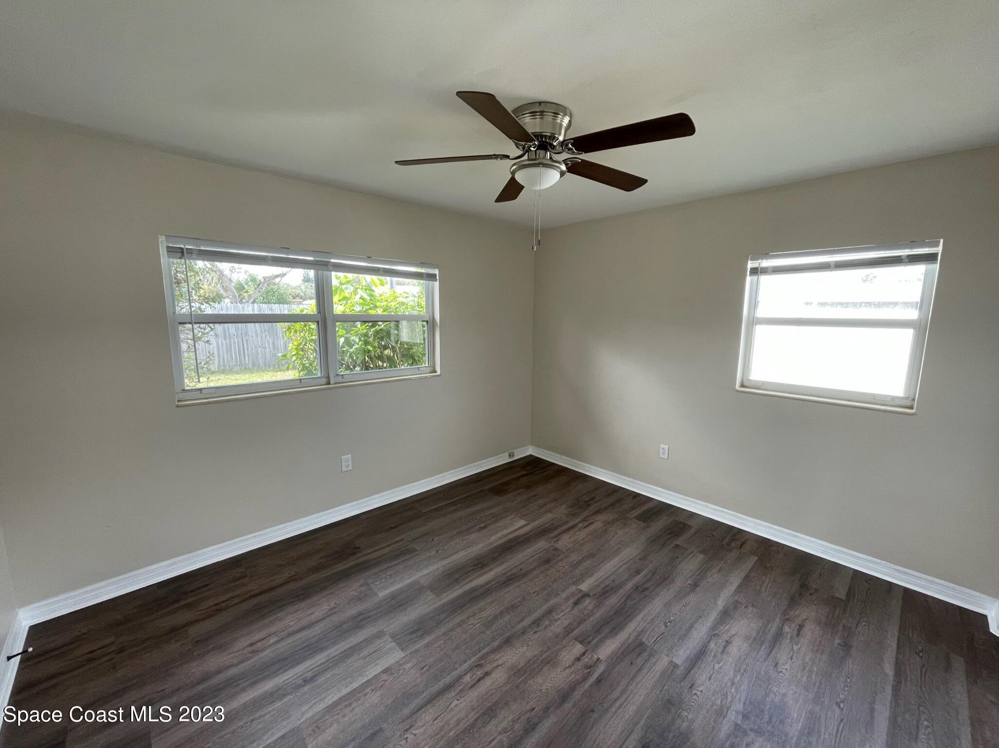 1820 Harrison Avenue Melbourne, FL 32935 - Photo 16 of 20 a view of an empty room with wooden floor and a window