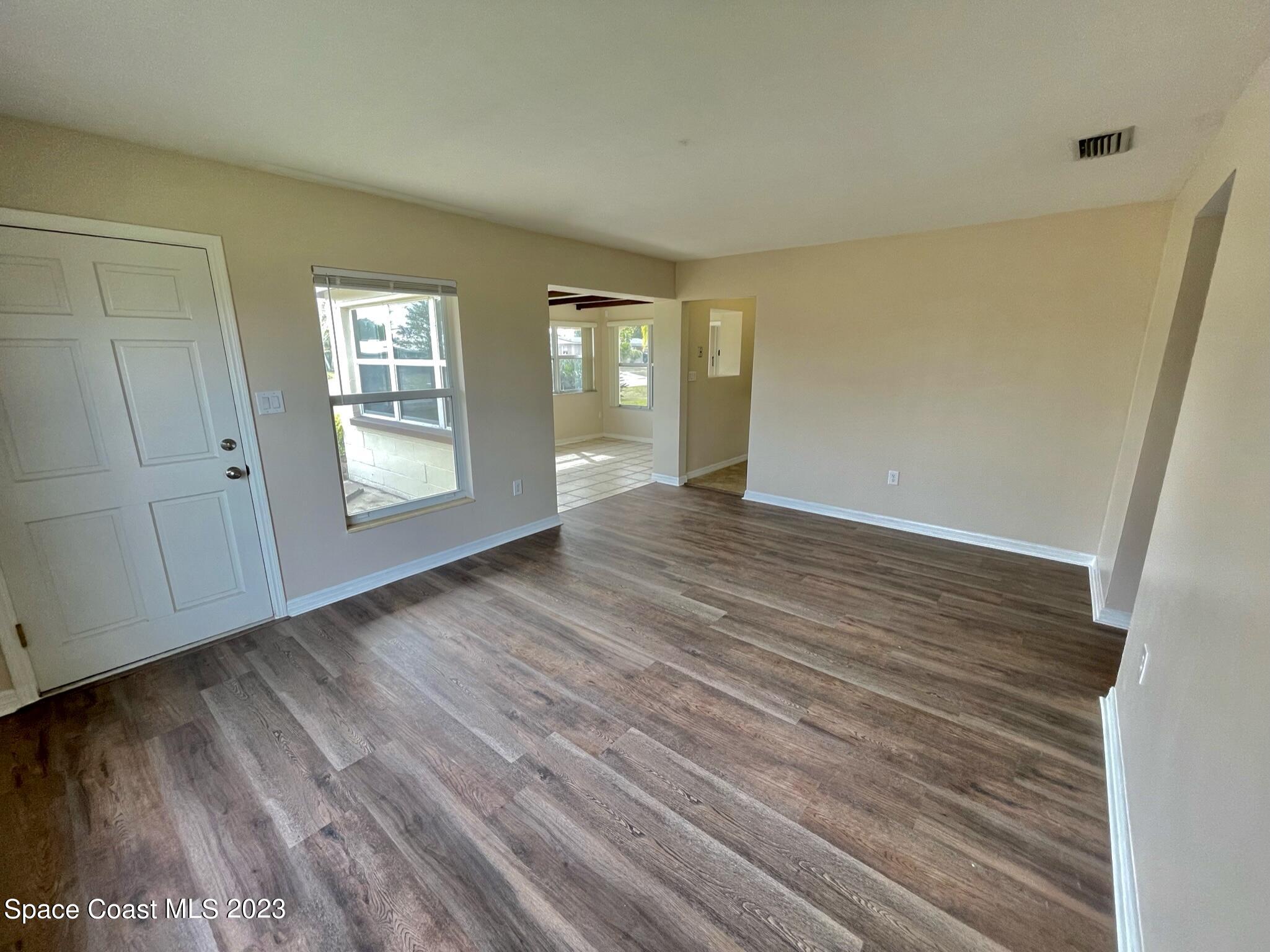 1820 Harrison Avenue Melbourne, FL 32935 - Photo 4 of 20 a view of an empty room with wooden floor and a window