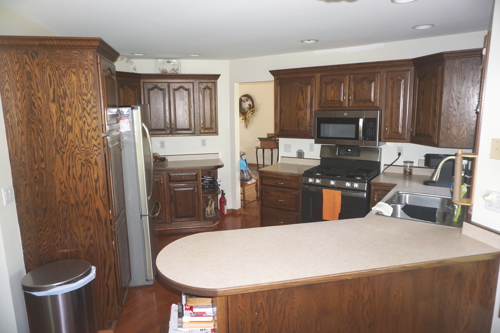 4914 Highway 113 Kankakee, IL 60901 - Photo 17 of 54 a kitchen with kitchen island a stove a sink and a refrigerator