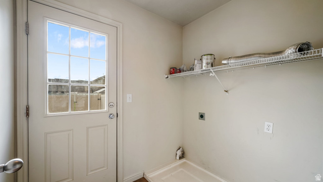 983 South 1850th Street West Springville, UT 84663 - Photo 8 of 30 Laundry area featuring a utility door with a divided light window, a wire shelving unit, and plumbing hookups