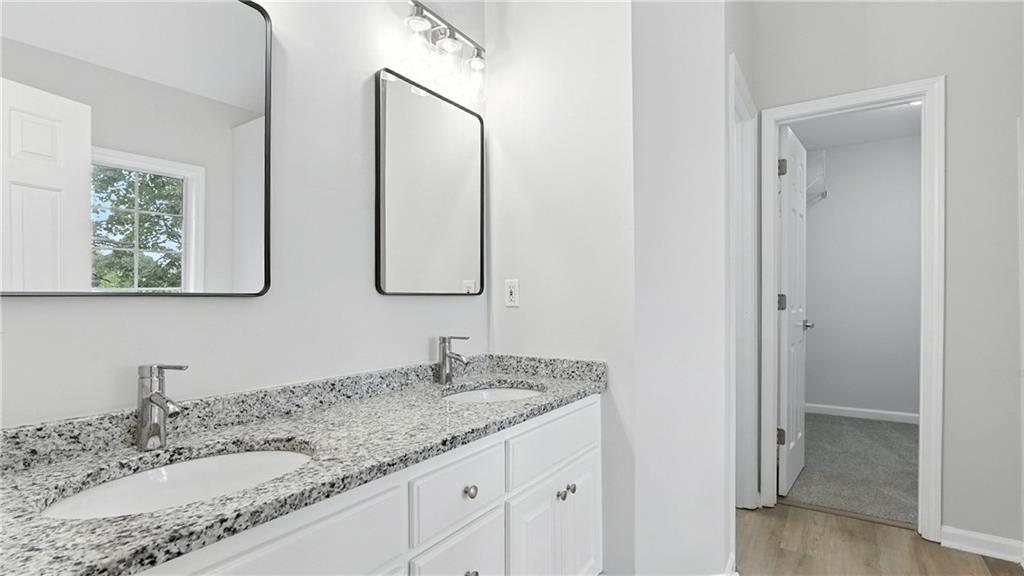 730 Reeves Lake Drive Southwest Marietta, GA 30064 - Photo 13 of 16 a bathroom with a granite countertop double vanity sink and a mirror